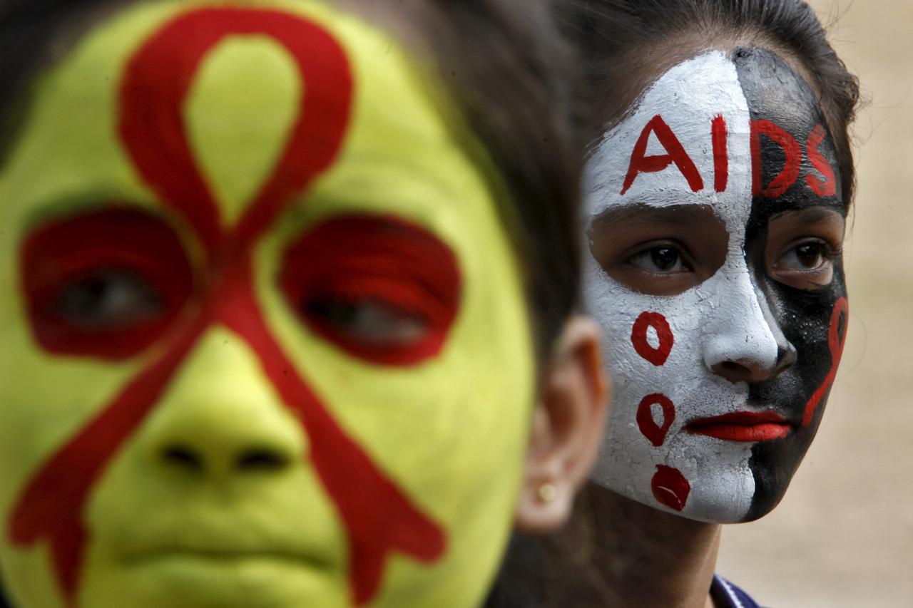 Students wait for their face paint to dry before an AIDS awareness rally inside a school on the eve of World AIDS Day, in Chandigarh, India, November 30, 2015. REUTERS/Ajay Verma