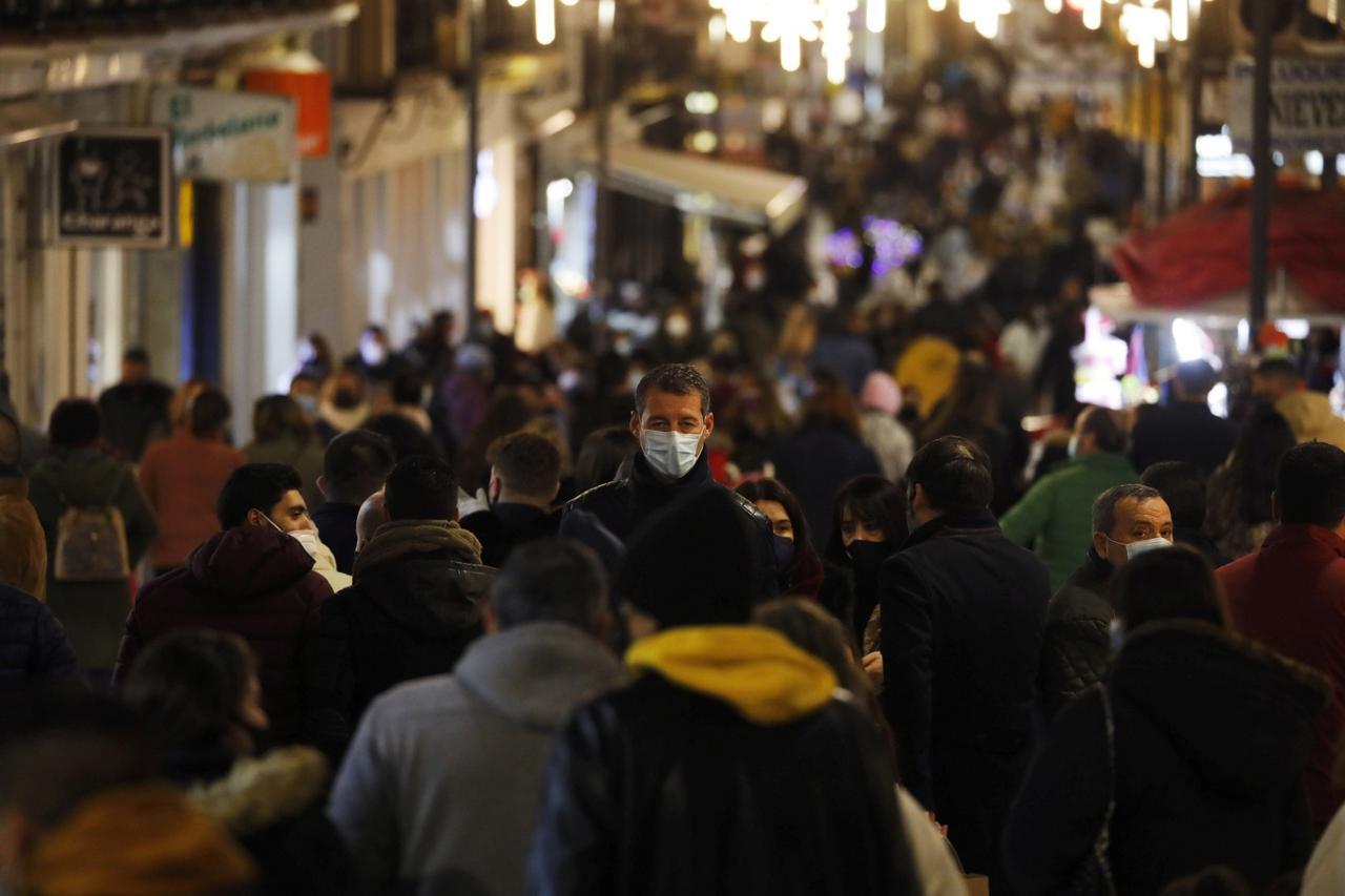 People walk along La Bola shopping street on the eve of Epiphany, with the traditional parade cancelled due to coronavirus disease (COVID-19) restrictions, in Ronda