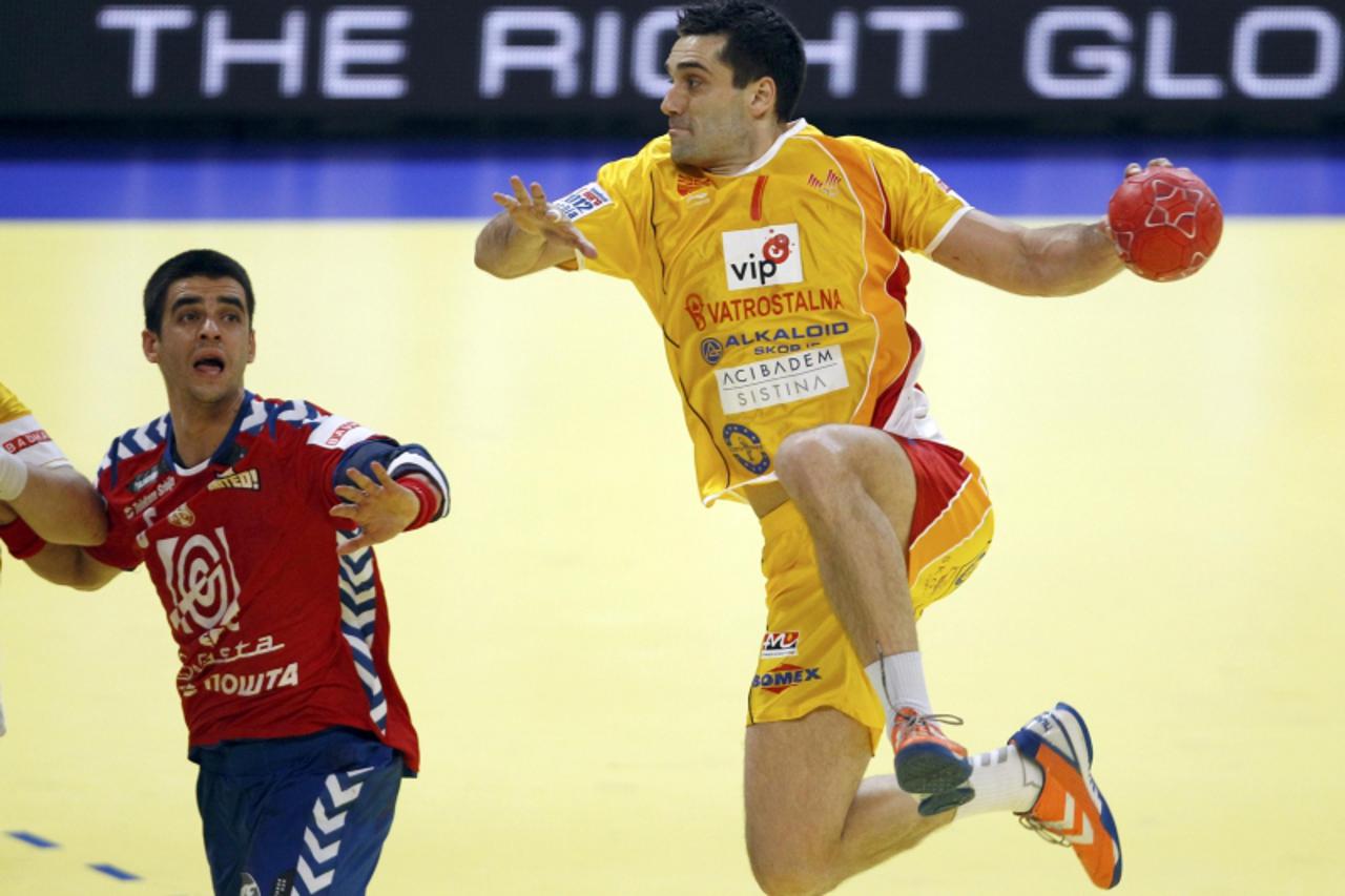 'Macedonia\'s Kiril Lazarov (R) attempts to score as Serbia\'s Marko Vujin (L) watches during their Men\'s European Handball Championship main round group 1 match in Belgrade January 25, 2012.        