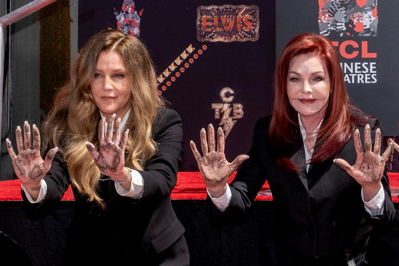 FILE PHOTO: Lisa Marie Presley and her mother Priscilla Presley pose after placing their handprints in cement at TCL Chinese theatre