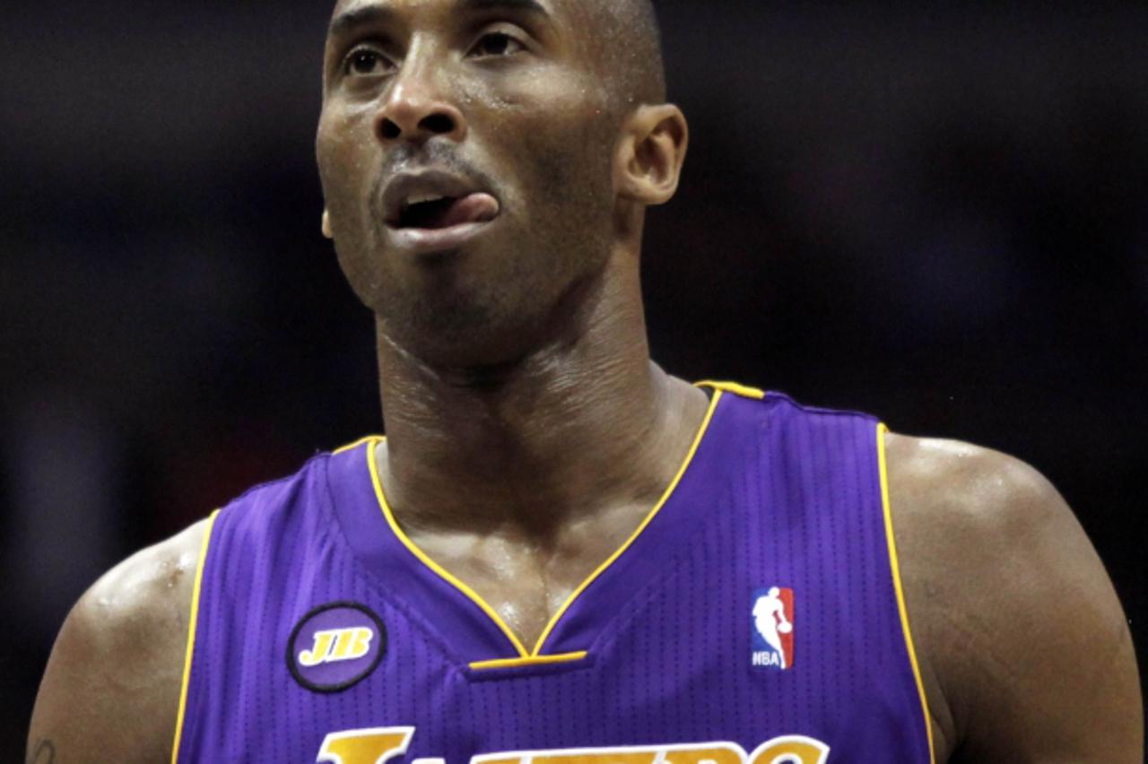 'Los Angeles Lakers guard Kobe Bryant sticks his tongue out while waiting to take a free throw shot against the Milwaukee Bucks during the first half of a NBA basketball game in Milwaukee, Wisconsin M