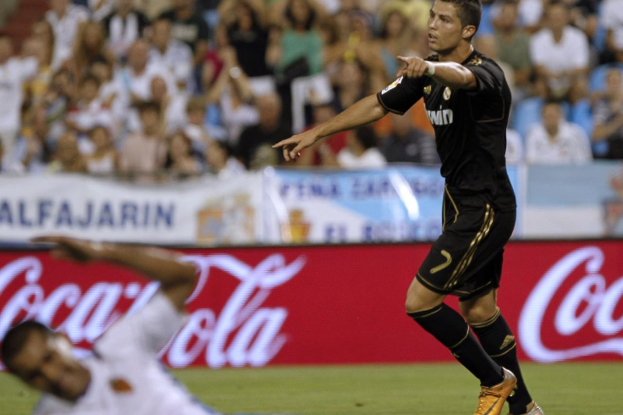 'Real Madrid\'s Portuguese forward Cristiano Ronaldo celebrates after scoring his team\'s second goal against Zaragoza during their Spanish League football match at La Romareda stadium in Zaragoza on 