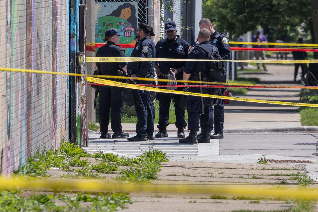 Officers and rescue workers stand near police shooting in Milwaukee