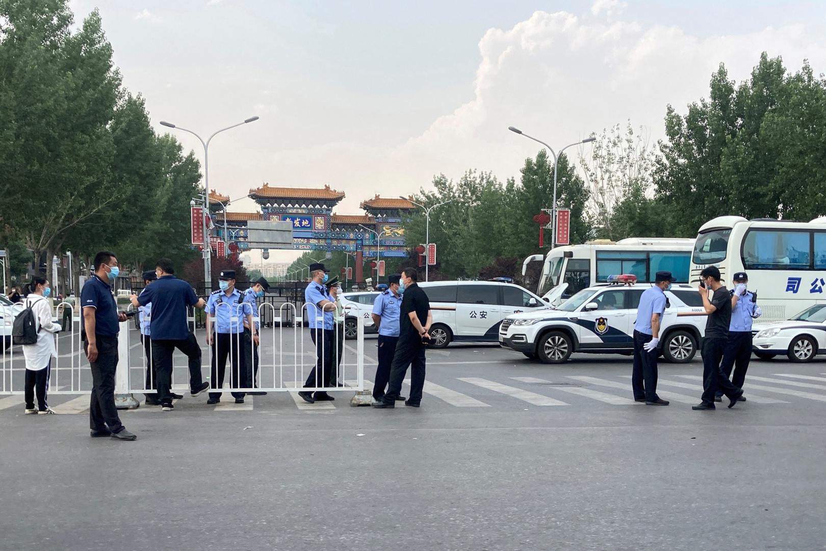 FILE PHOTO: Police officers wearing face masks are seen outside an entrance of the Xinfadi wholesale market, which has been closed for business after new coronavirus infections were detected, in Beijing FILE PHOTO: Police officers wearing face masks are seen outside an entrance of the Xinfadi wholesale market, which has been closed for business after new coronavirus infections were detected, in Beijing, China June 13, 2020. REUTERS/Martin Pollard/File Photo Martin Pollard