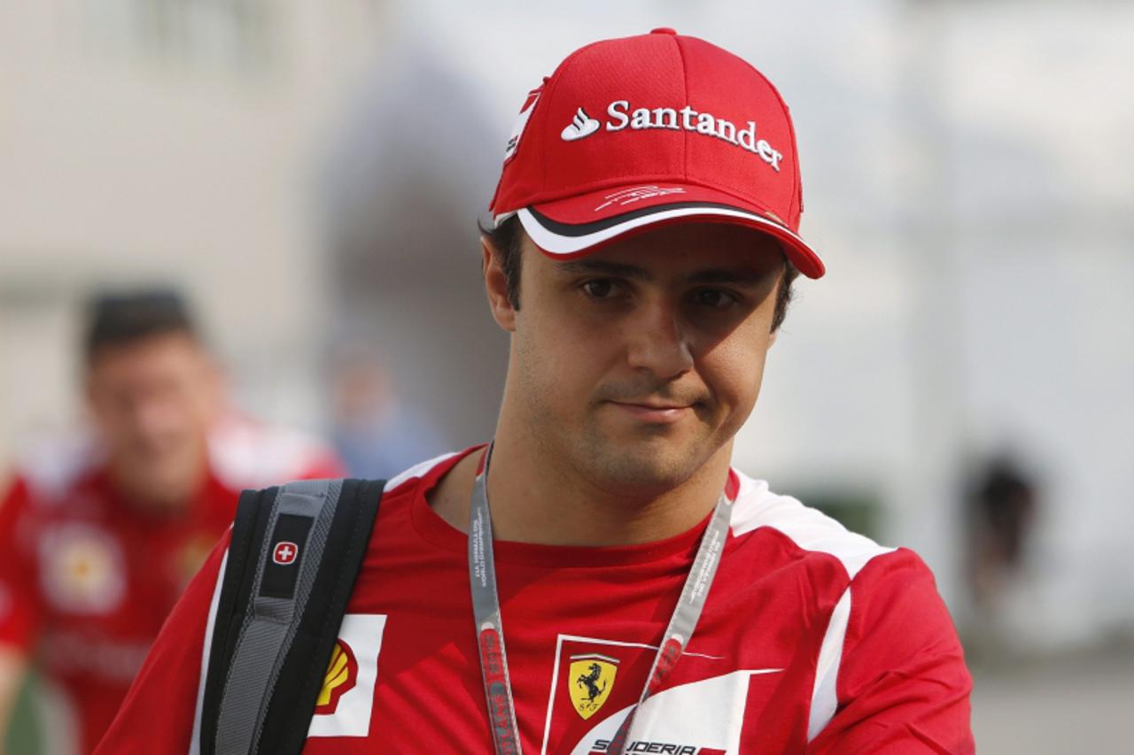 'Ferrari Formula One driver Felipe Massa of Brazil walks through the paddock ahead of the Singapore F1 Grand Prix September 20, 2012. The Singapore F1 night race will take place on September 21-23. RE