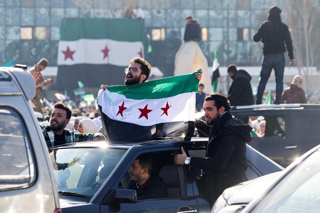 People gather after Syria's Bashar al-Assad was ousted, in central Damascus