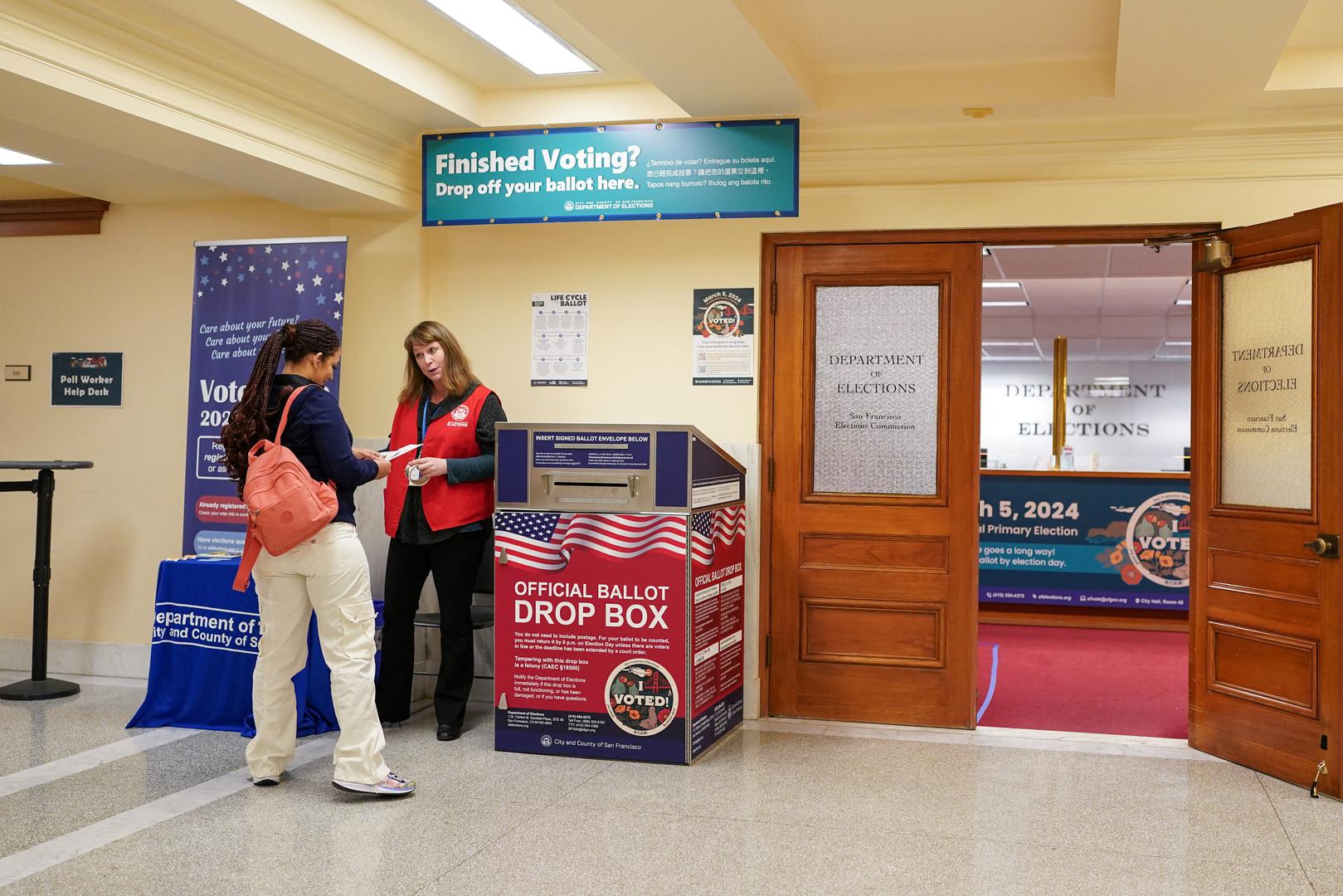 A Department of Elections worker speaks with a voter next to an official ballot drop box during early voting, a day ahead of the Super Tuesday primary election, at the San Francisco City Hall voting center in San Francisco, California, U.S. March 4, 2024. REUTERS/Loren Elliott Photo: LOREN ELLIOTT/REUTERS