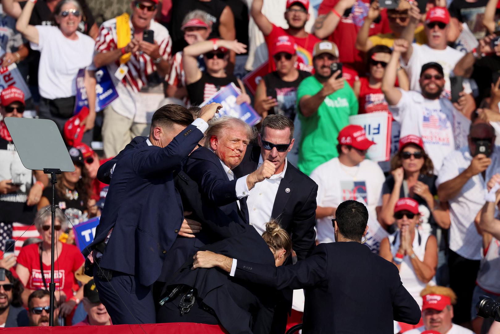 Republican presidential candidate and former U.S. President Donald Trump is assisted by U.S. Secret Service personnel after gunfire rang out during a campaign rally at the Butler Farm Show in Butler, Pennsylvania, U.S., July 13, 2024. REUTERS/Brendan McDermid Photo: BRENDAN MCDERMID/REUTERS