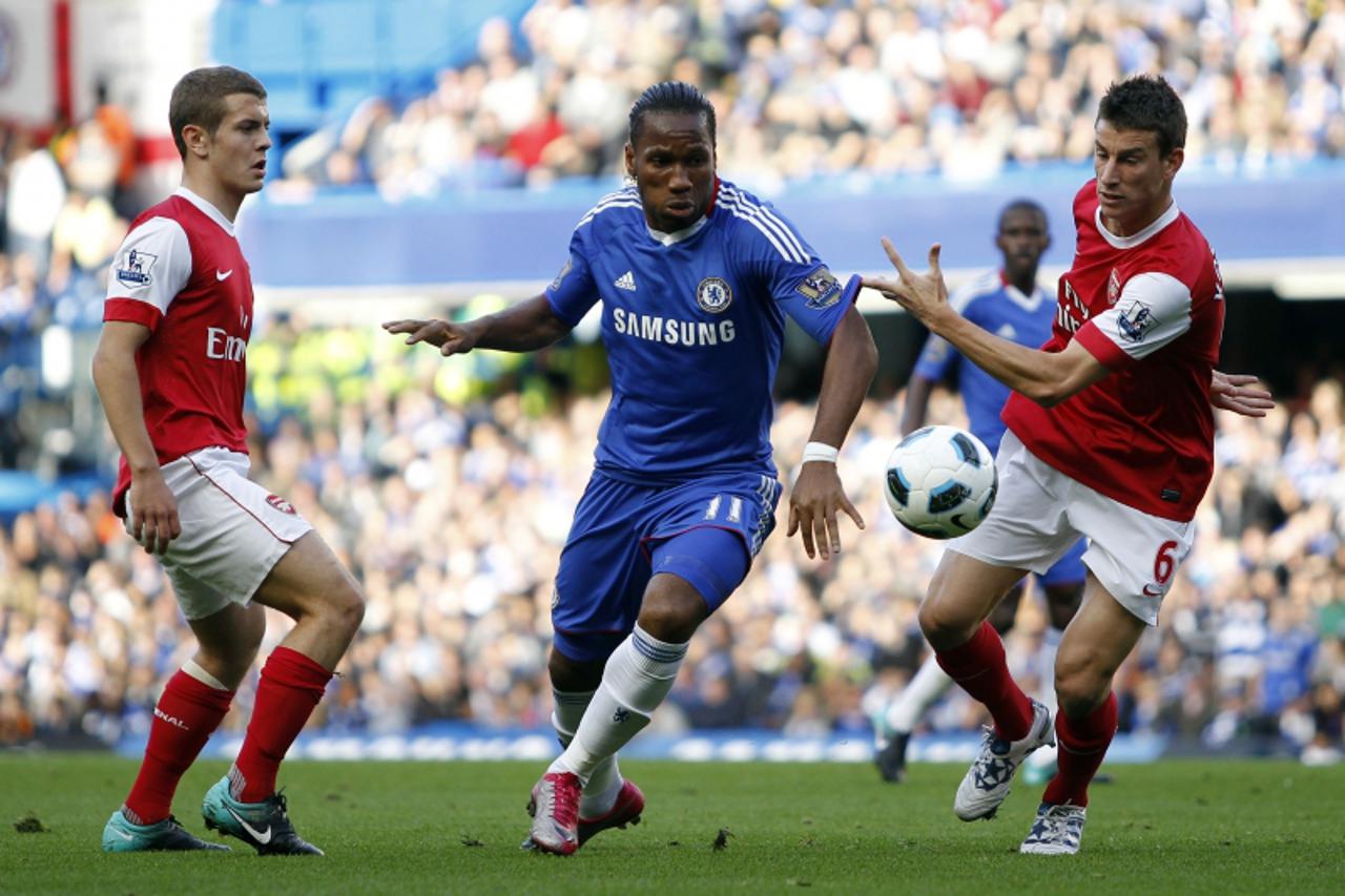 'Chelsea\'s Ivory Coast footballer Didier Drogba (C) vies with Arsenal\'s Laurent Koscielny (R) and Arsenal\'s Jack Wilshere during a Premier League match at Stamford Bridge in London,  England on Oct