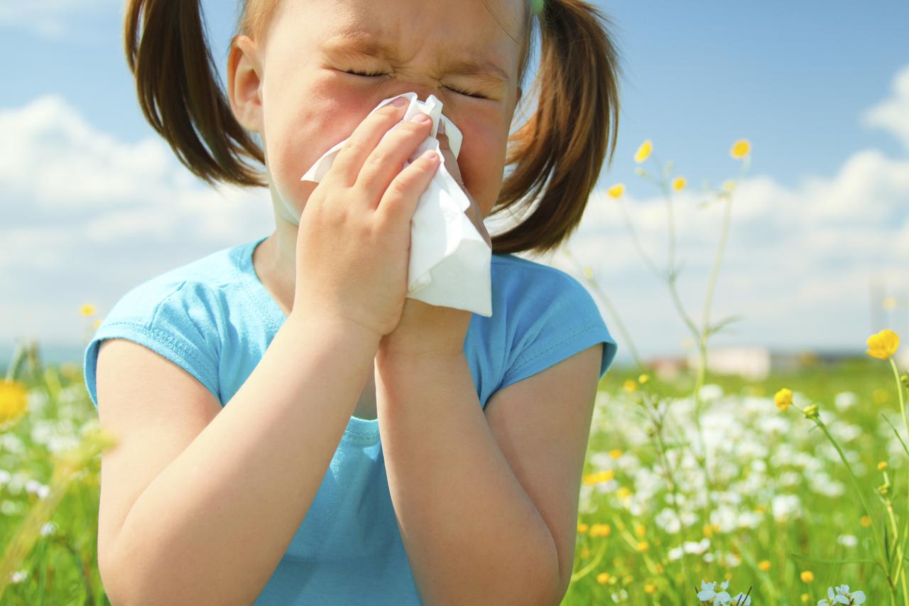 Little girl is blowing her nose