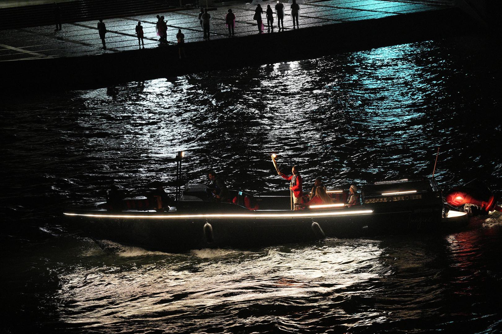 Paris 2024 Olympics - Opening Ceremony - Paris, France - July 26, 2024. Rafael Nadal of Spain holds the Olympic torch during the opening ceremony of the Paris 2024 Olympic Games.     Xu Chang/Pool via REUTERS Photo: Xu Chang/REUTERS