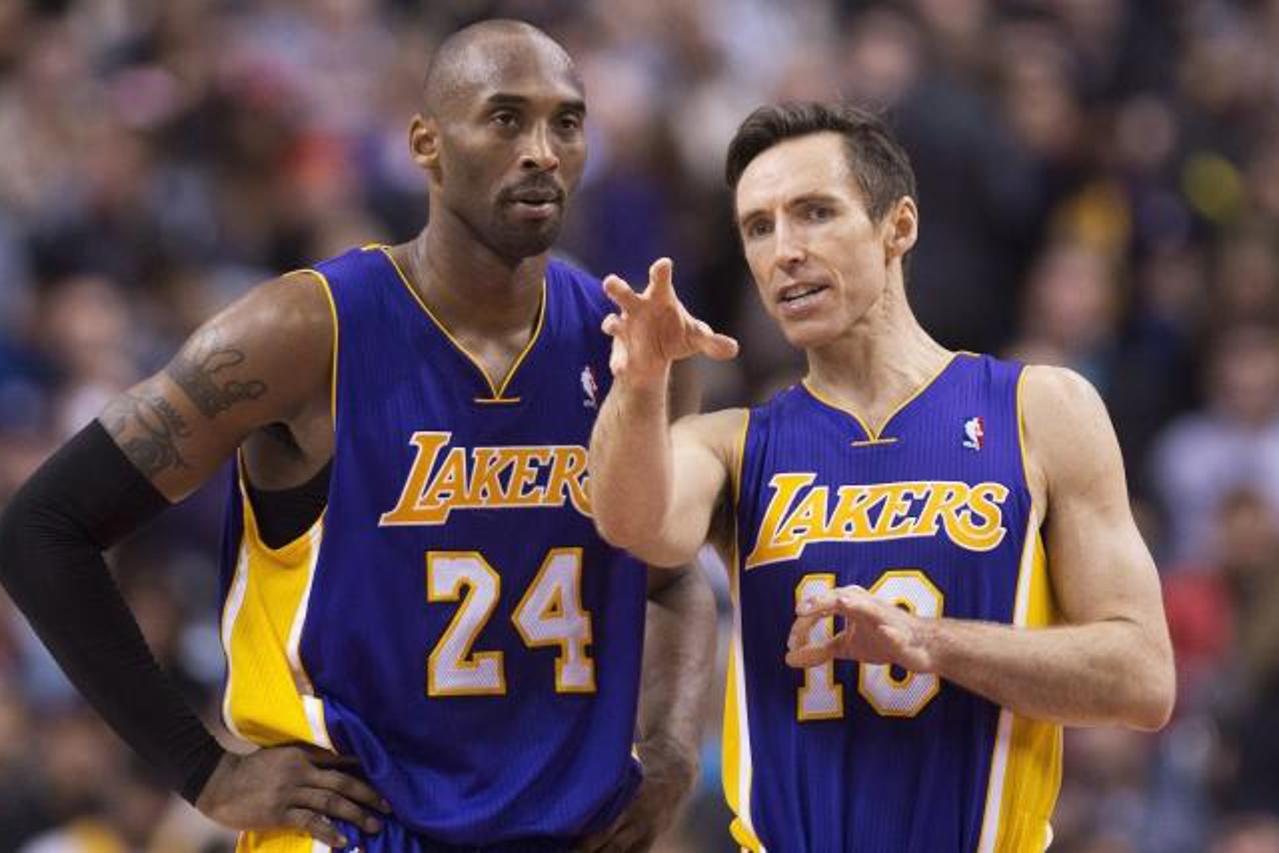 'Los Angeles Lakers guards Kobe Bryant, right, and Steve Nash, right, talk during a time-out while playing against the Toronto Raptors during first half NBA basketball action in Toronto on Sunday, Jan