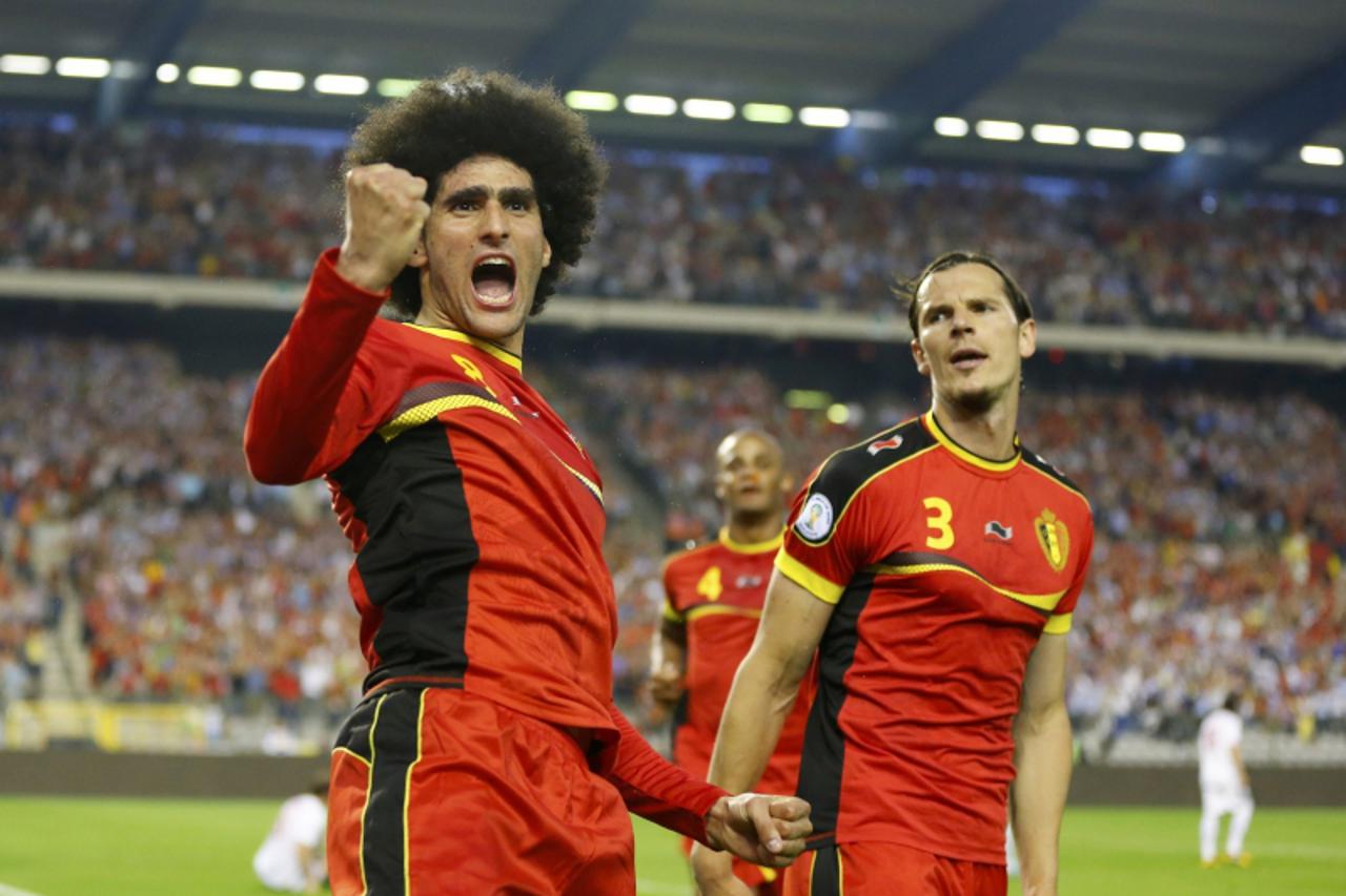 'Belgium\'s Marouane Fellaini (L) celebrates after scoring against Serbia during their 2014 World Cup qualifying soccer match at the King Baudouin stadium in Brussels June 7, 2013.         REUTERS/Yve