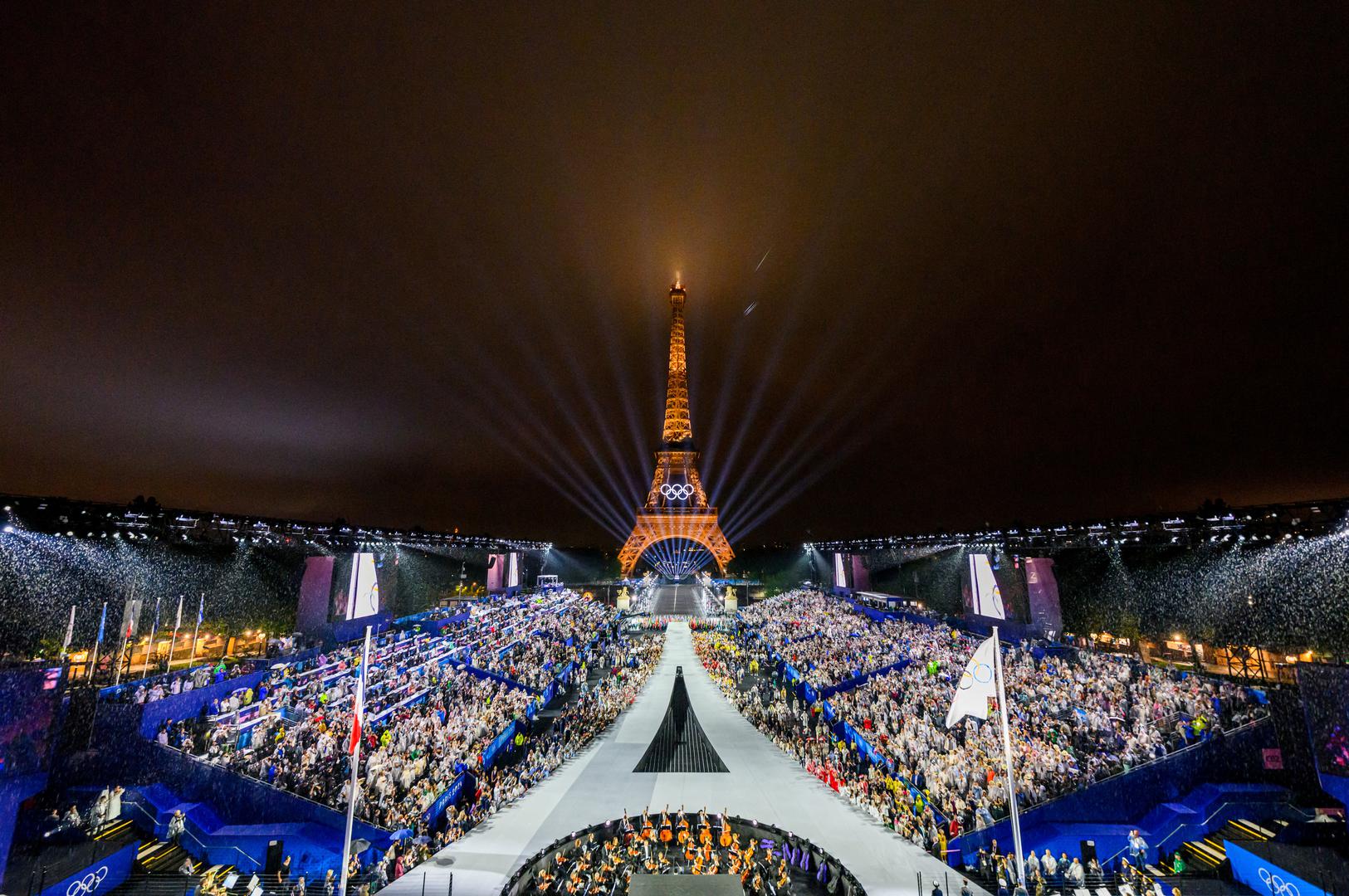 Paris 2024 Olympics - Opening Ceremony - Paris, France - July 26, 2024. Overview of the Trocadero venue, with the Eiffel Tower looming in the background while the Olympic flag is being raised, during the opening ceremony of the Paris 2024 Olympic Games.  FRANCOIS-XAVIER MARIT/Pool via REUTERS      TPX IMAGES OF THE DAY Photo: FRANCOIS-XAVIER MARIT/REUTERS