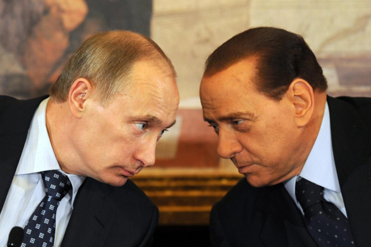 'Italian Prime Minister Silvio Berlusconi (L) and his Russian counterpart Vladimir Putin talk during a joint press conference at the Villa Gernetto on April 26, 2010 in Lesmo near Monza.  AFP PHOTO / 