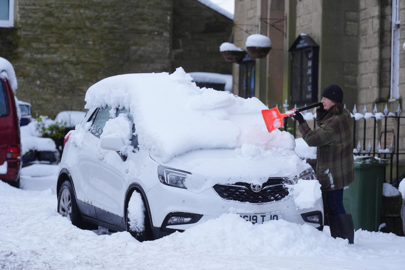 A person clears snow from a car in Allendale, Northumberland. Weather warnings remain in force across much of the UK on Monday with adverse conditions, including flooding from heavy rain and thawing snow. Picture date: Monday January 6, 2025. Photo: Owen Humphreys/PRESS ASSOCIATION