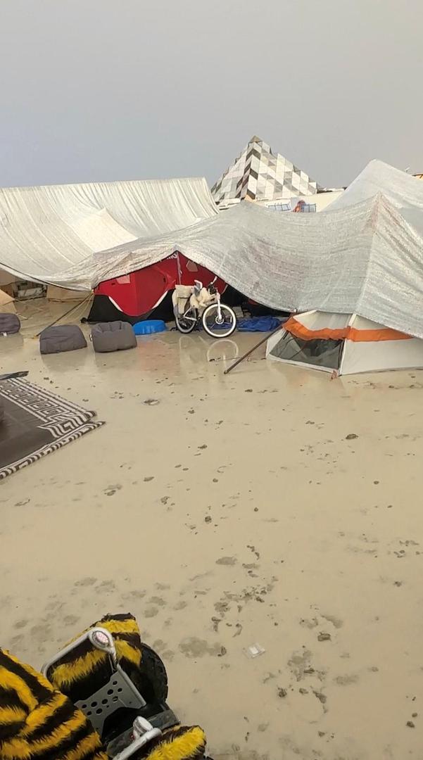 Tents are seen covered to protect them from the rain as the mud covers the ground at the site of the Burning Man festival in Black Rock, Nevada, U.S., September 1, 2023, in this screen grab obtained from a social media video. Paul Reder/via REUTERS  THIS IMAGE HAS BEEN SUPPLIED BY A THIRD PARTY. MANDATORY CREDIT. NO RESALES. NO ARCHIVES. Photo: PAUL REDER/REUTERS