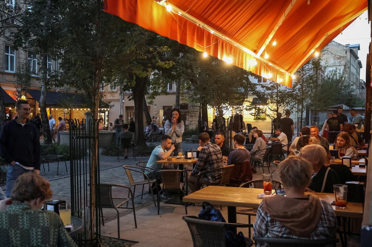 People rest in a cafe in central Lviv