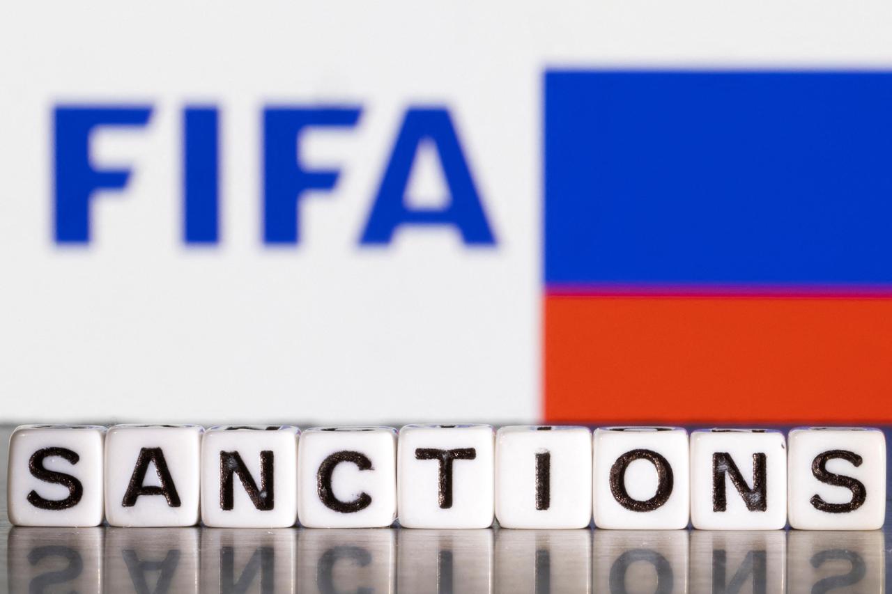 Illustration shows letters arranged to read "Sanctions" in front of FIFA logo and Russian flag colors