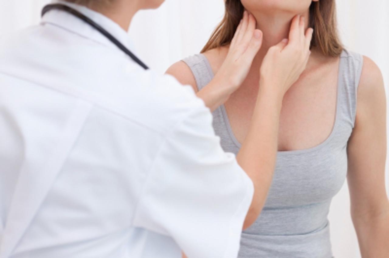 'Doctor examining patients throat'