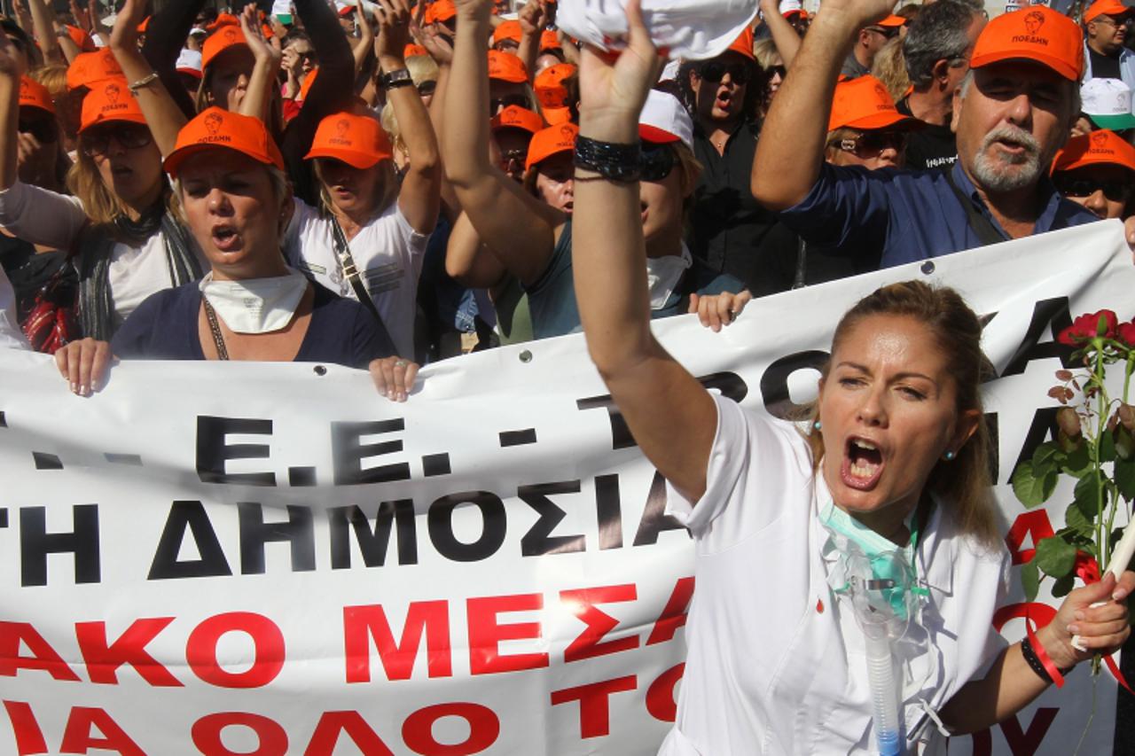 'epa02964630 Medical personel of Athens\' hospitals shout slogans as they march in central Athens, Greece, on 13 October 2011. Reports state that many public services ground to a halt in Athens while 