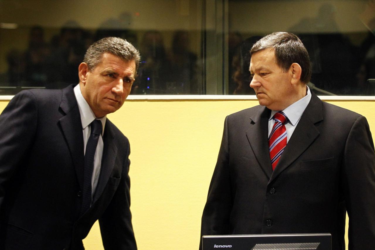 'Former Croatian Army Generals Ante Gotovina, left, and Mladen Markac, right, enter the courtroom of the Yugoslav war crimes tribunal (ICTY) for their appeal judgement in The Hague, on November 16, 20