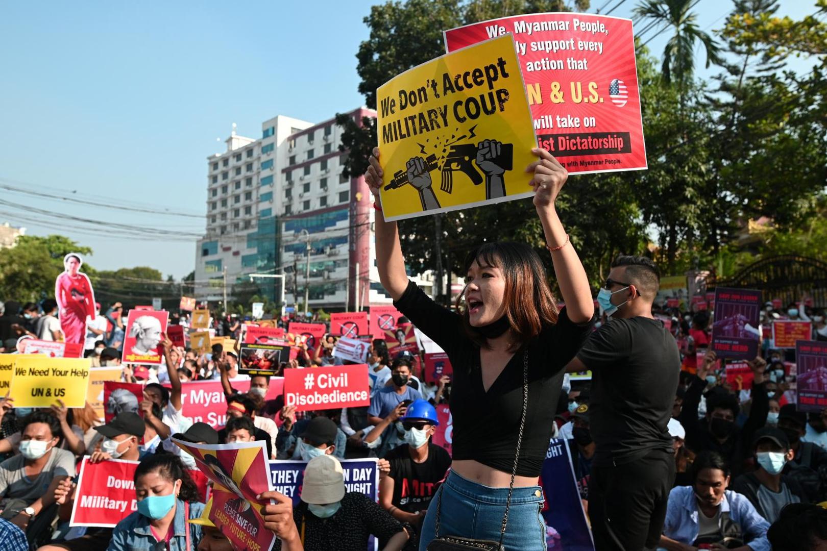 Protest against the military coup, in Yangon Demonstrators hold placards during a protest against the military coup in Yangon, Myanmar, February 15, 2021. REUTERS/Stringer STRINGER