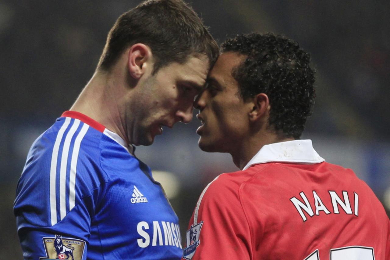 \'Manchester United\'s Nani (R) locks heads with Chelsea\'s Branislav Ivanovic during their English Premier League soccer match at Stamford Bridge in London March 1, 2011 .  REUTERS/Eddie Keogh  (BRIT