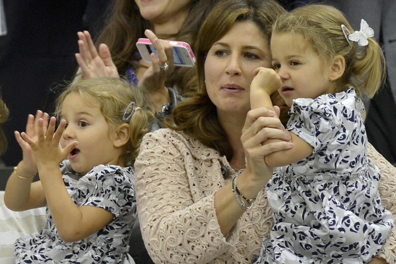 'The wife of Roger Federer of Switzerland, Mirka Federer (C) with their two-year-old twins Charlene Riva and Myla Rose, celebrates after Federer defeated Andy Murray of Britain in their men\'s singles