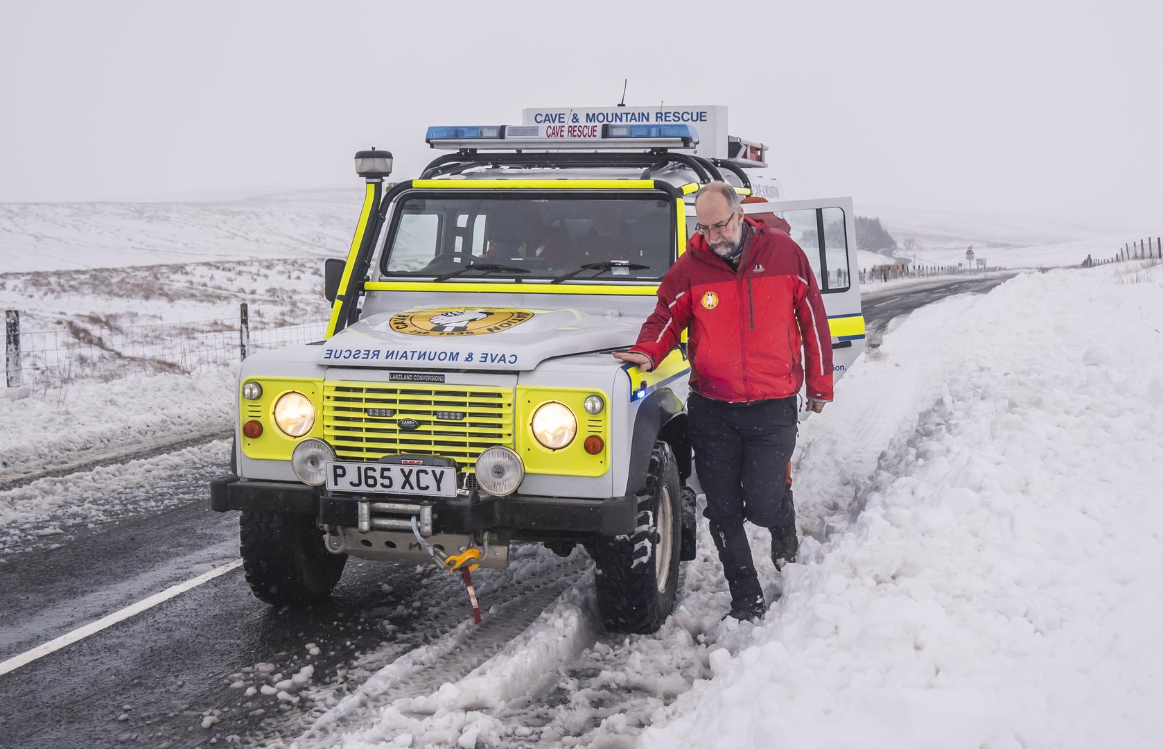 A member of a Mountain Rescue team after helping to clear cars from a snow drift near Ribblehead, in North Yorkshire. Large parts of the UK are facing heavy snow and freezing rain, which is likely to cause disruption, after two amber weather warnings came into force. Stranded vehicles on the roads, delayed or cancelled rail and air travel, and power cuts are all likely as the country grapples with a week-long spell of wintry conditions, the Met Office said. Picture date: Monday January 6, 2025. Photo: Danny Lawson/PRESS ASSOCIATION