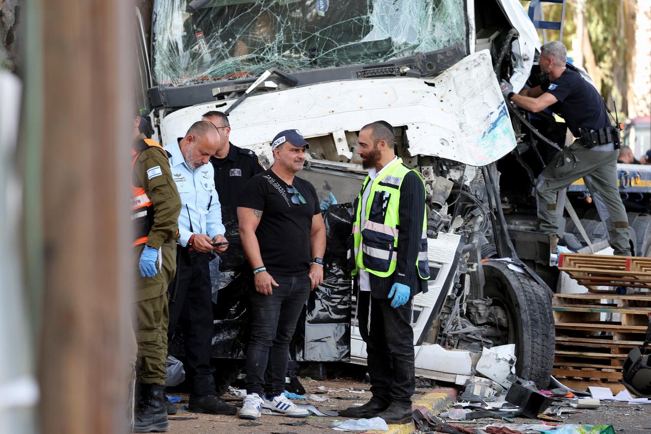 Israeli emergency services work at the scene where a truck rammed into pedestrians at a bus stop, in Ramat Hasharon