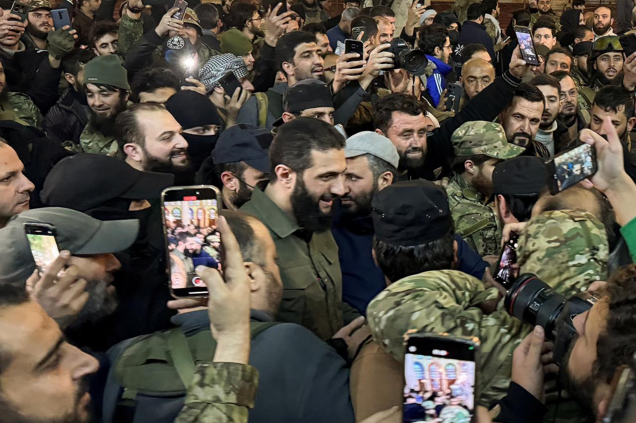 Top rebel commander Abu Mohammed al-Golani greets the crowd at Ummayad Mosque in Damascus