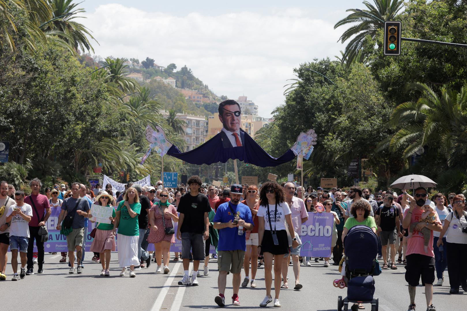 People hold a banner with the image of Andalusian Regional President Juan Manuel Moreno Bonilla as they take part in a demonstration against mass tourism, under the motto "Malaga to live, not to survive" in reaction to real estate high prices, driven by the increase of tourist accommodations, in Malaga, Spain, June 29, 2024. REUTERS/Jon Nazca Photo: JON NAZCA/REUTERS