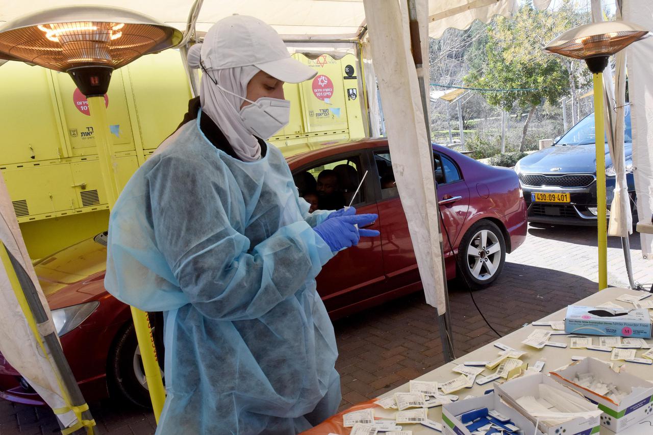 A Medical Worker Administers A COVID-19 Test To An Israeli