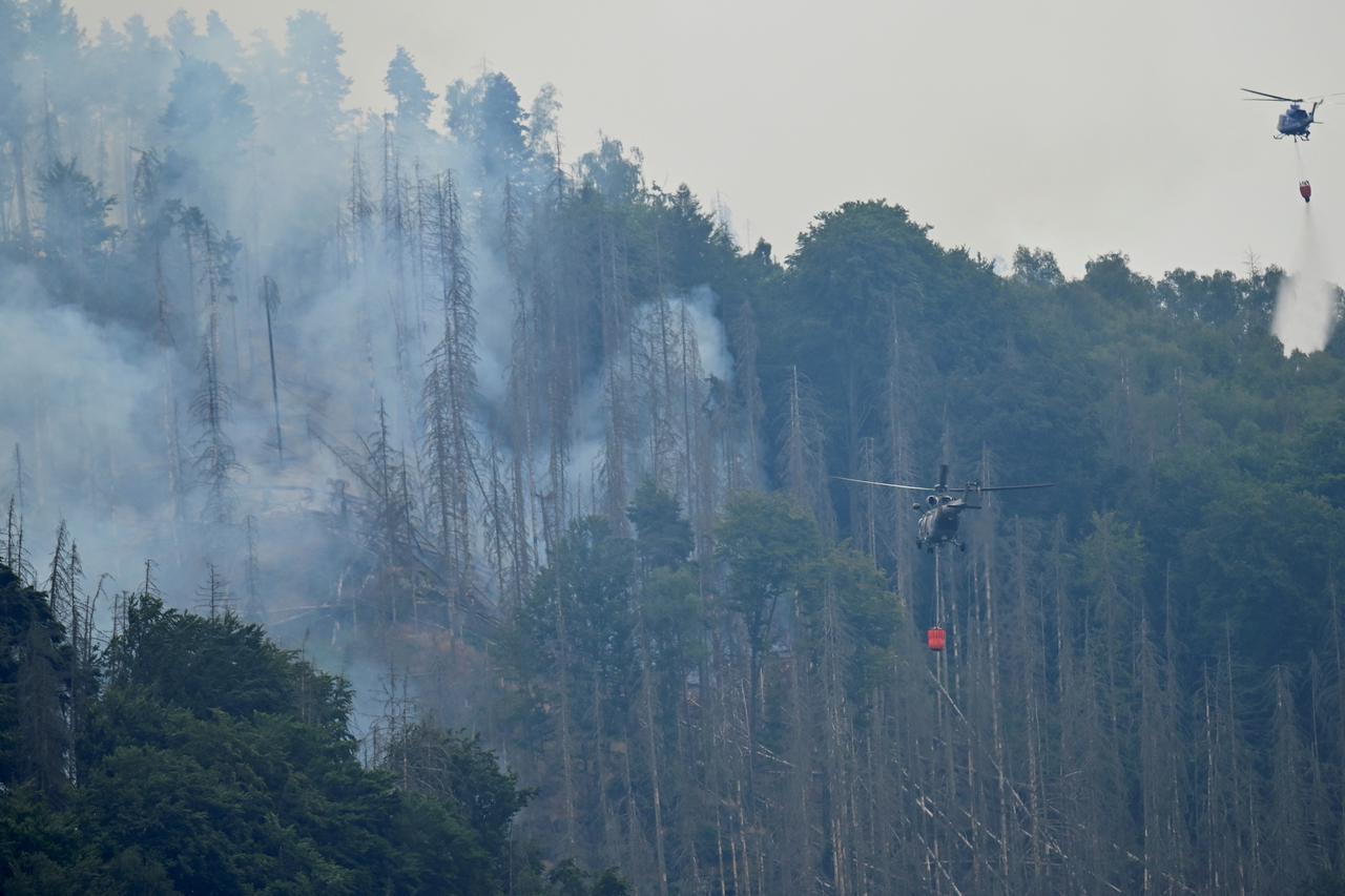 Helicopters help during a forest fire in Schmilka