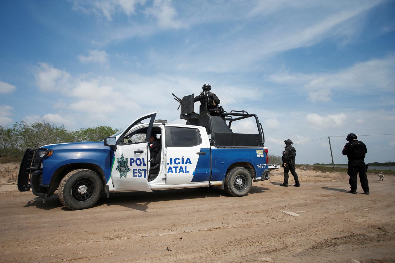 Authorities work the scene where two of four Americans kidnapped by gunmen were found dead, in Matamoros