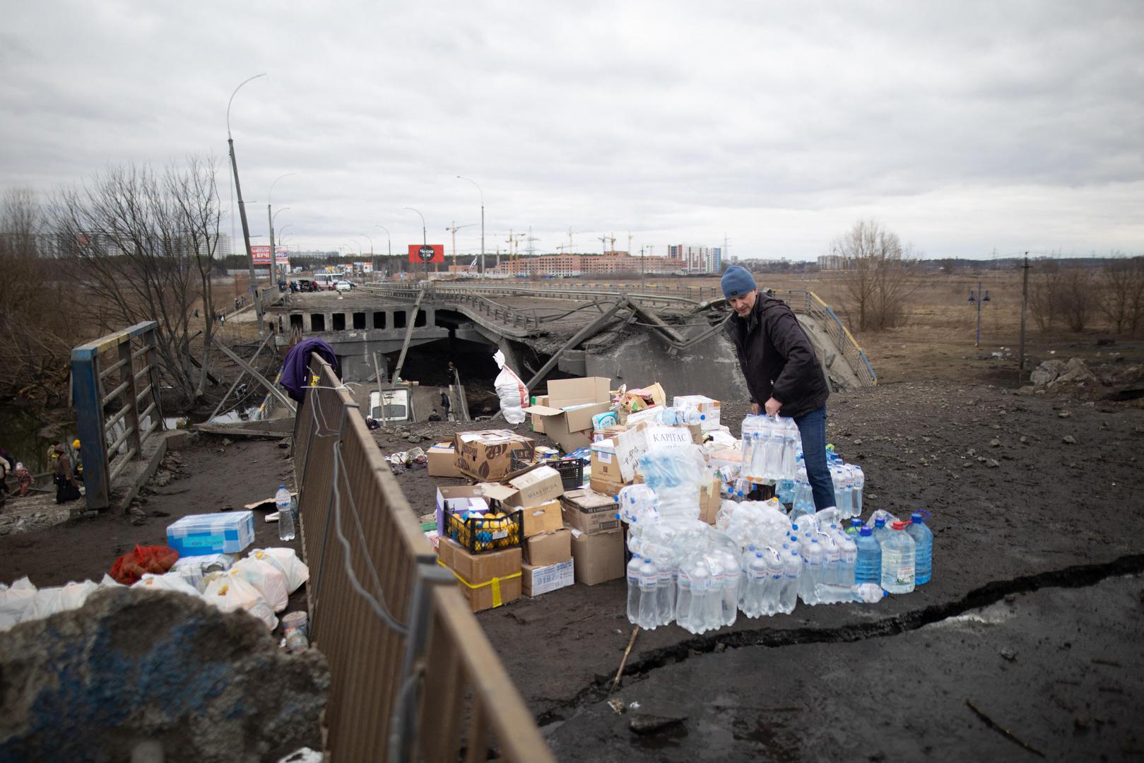 People cross a destroyed bridge as they evacuate the city of Irpin, northwest of Kyiv, during heavy shelling and bombing on March 5, 2022, 10 days after Russia launched a military invasion on Ukraine. Photo by Raphael Lafargue/ABACAPRESS.COM