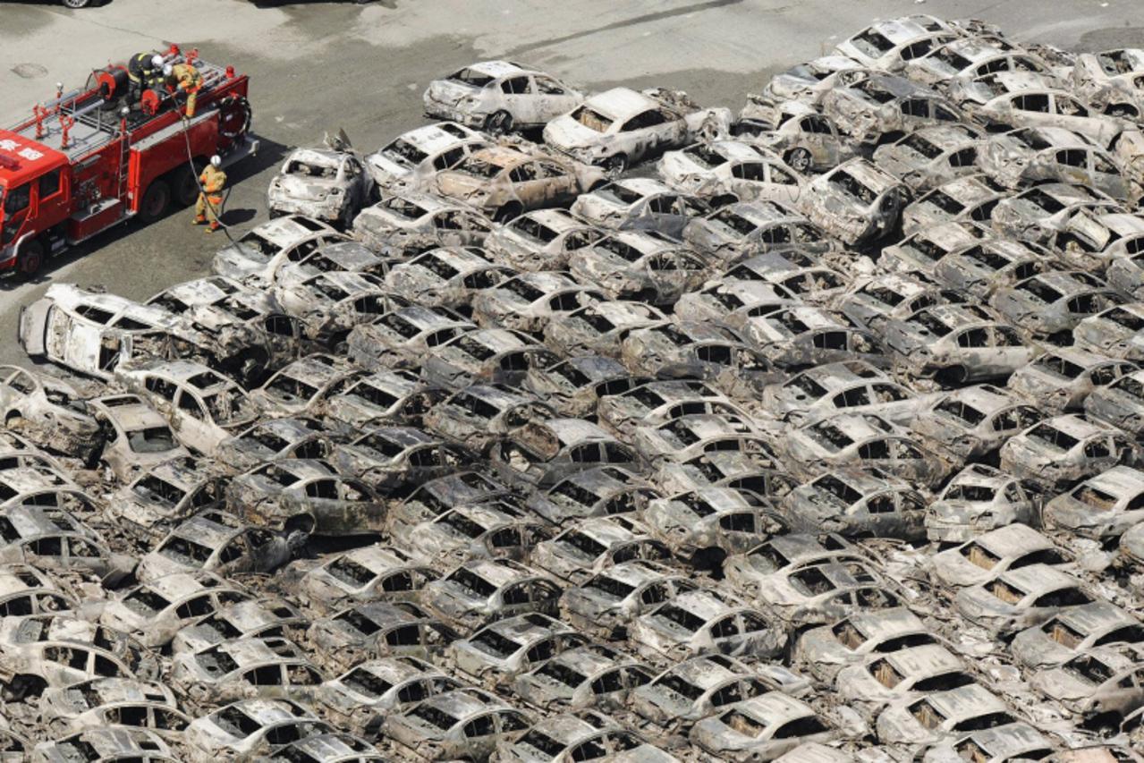 'Burned-out cars are pictured at Hitachi Harbour in Ibaraki Prefecture in northeastern Japan March 12, 2011. Japan confronted devastation along its northeastern coast on Saturday, with fires raging an