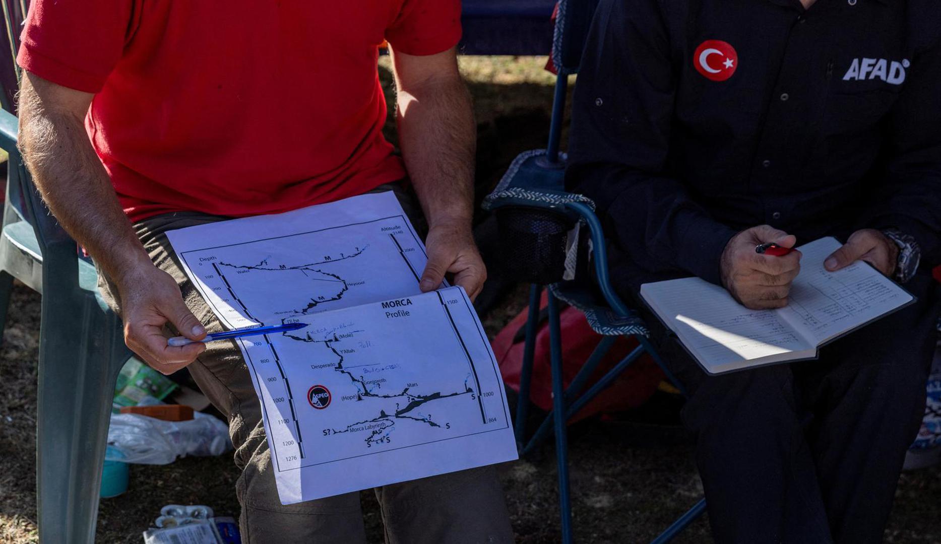 A rescuer holds a map of the Morca Cave during a meeting as a rescue operation continues to reach U.S. caver Mark Dickey who fell ill and became trapped some 1,000 meters (3,280 ft) underground, near Anamur in Mersin province, southern Turkey September 8, 2023. REUTERS/Umit Bektas Photo: UMIT BEKTAS/REUTERS