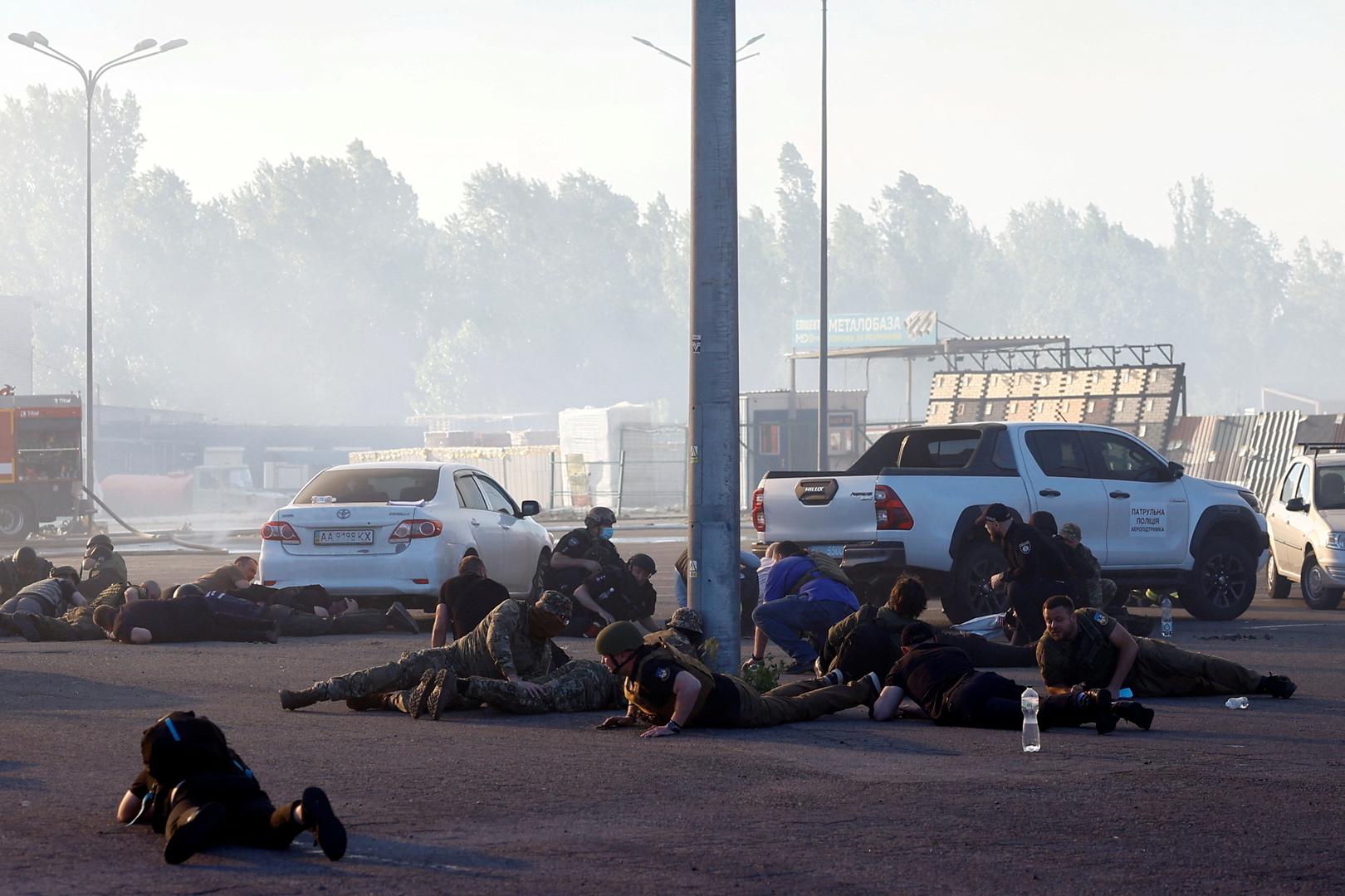 People take cover, after the announcement of a Russian missile attack towards Kharkiv, at the site of a household item shopping mall which was hit by a Russian air strike, amid Russia's attack on Ukraine, in Kharkiv, Ukraine, May 25, 2024. REUTERS/Valentyn Ogirenko Photo: VALENTYN OGIRENKO/REUTERS