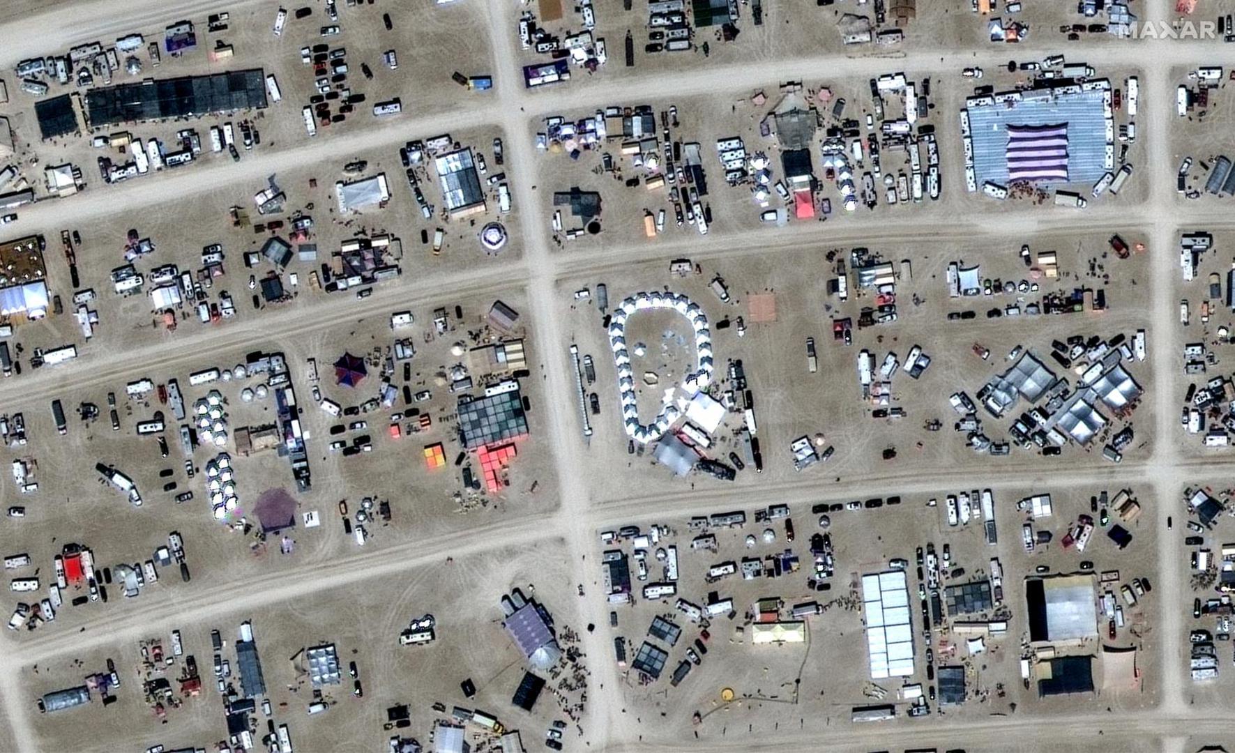 A satellite view shows a close up of tents during the 2023 Burning Man festival, in Black Rock Desert, Nevada, U.S., August 27, 2023.  Maxar Technologies/Handout via REUTERS THIS IMAGE HAS BEEN SUPPLIED BY A THIRD PARTY. NO RESALES. NO ARCHIVES. MANDATORY CREDIT. DO NOT OBSCURE LOGO. Photo: MAXAR TECHNOLOGIES/REUTERS