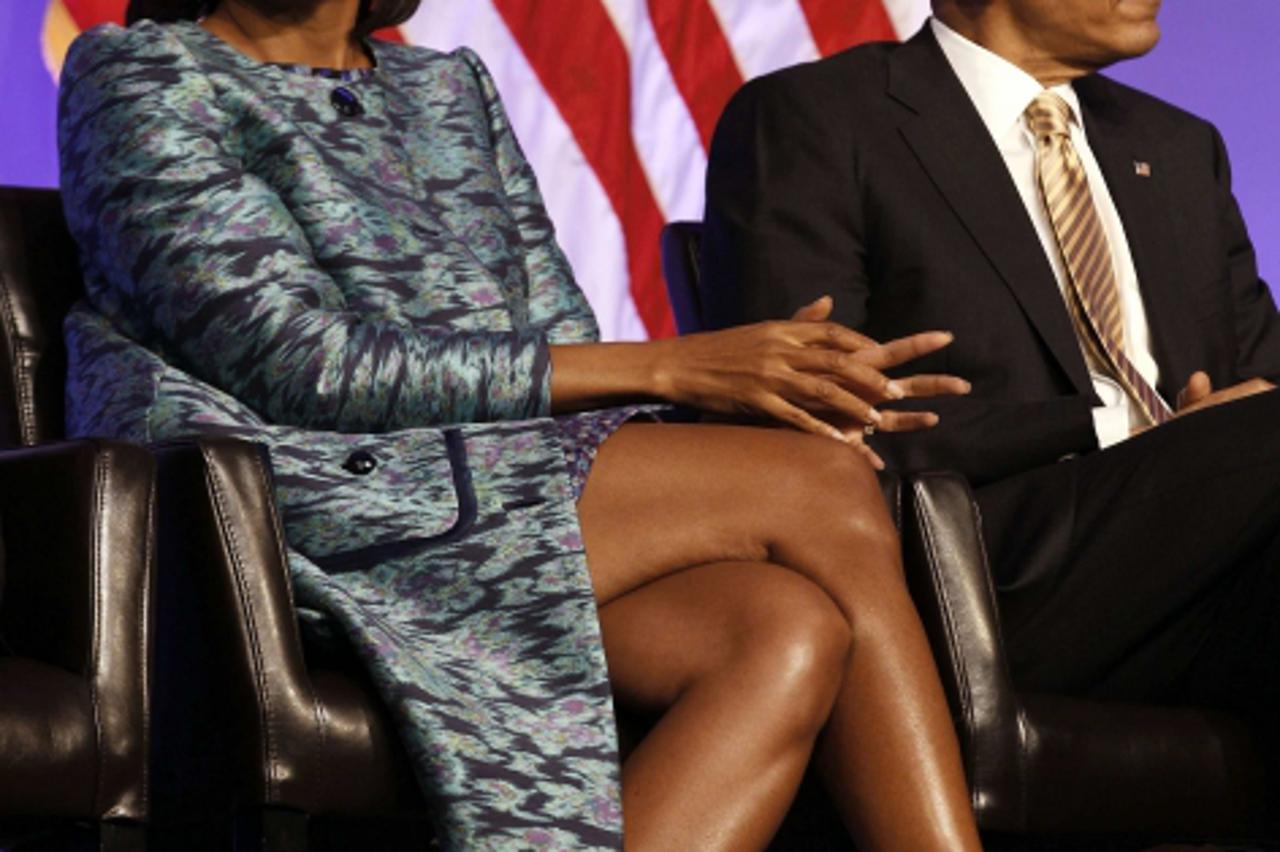 'First lady Michelle Obama sits next to U.S. President Barack Obama as they listen during the groundbreaking ceremony at the construction site of the Smithsonian National Museum of African American Hi