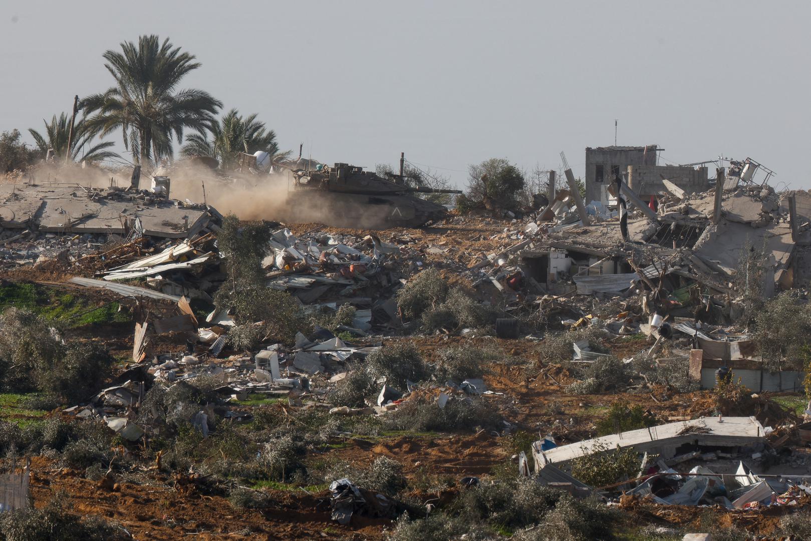 A tank manoeuvres next to destroyed buildings in central Gaza, amid the ongoing conflict between Israel and the Palestinian Islamist group Hamas, near the Israel-Gaza border, as seen from Israel, January 13, 2024. REUTERS/Amir Cohen Photo: AMIR COHEN/REUTERS