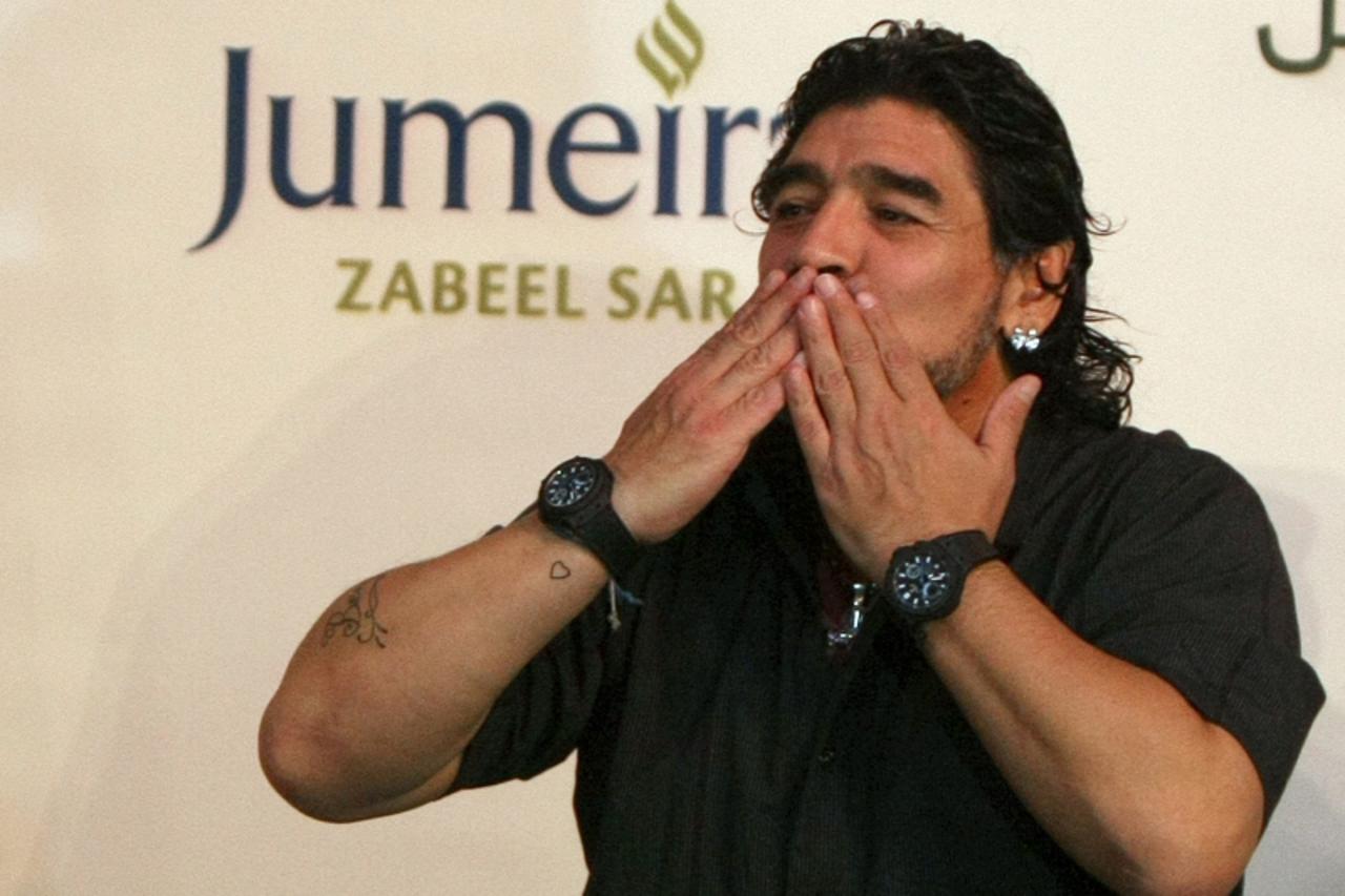 'Argentine football legend Diego Maradona blows a kiss to his fans following a press conference in Dubai, June 04, 2011. Maradona was introduced as the new coach of the United Arab Emirates al-Wasel f