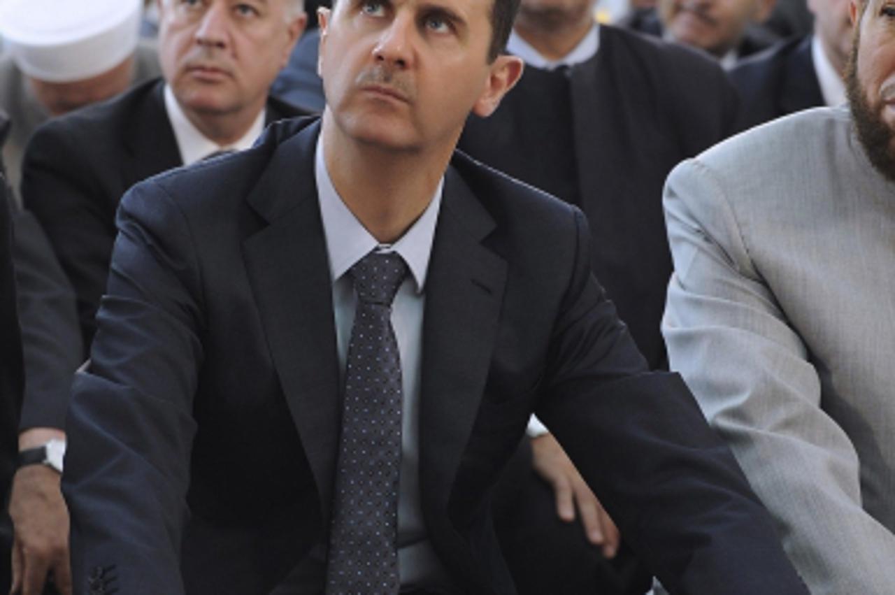 'Syria's President Bashar al-Assad attends Eid Al Fitr prayers at al-Hamad mosque in Damascus August 19, 2012, in this handout photograph released by Syria's national news agency SANA. REUTERS/Sana/