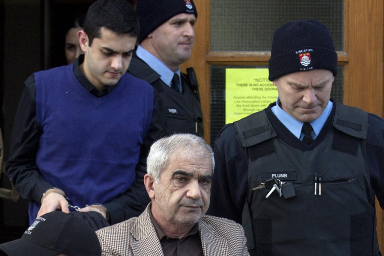 'Mohammad Shafia (bottom) and his son Hamed Shafia (L) leave the Frontenac County Courthouse in Kingston, Ontario January 29, 2012. The two, as well as Shafia\'s wife Tooba Mohammad Yahya, were found 