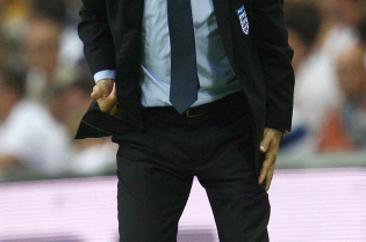 'England\'s head coach Fabio Capello reacts during their international friendly soccer match against Slovenia at Wembley Stadium in London September 5, 2009.    REUTERS/ Eddie Keogh   (BRITAIN SPORT S