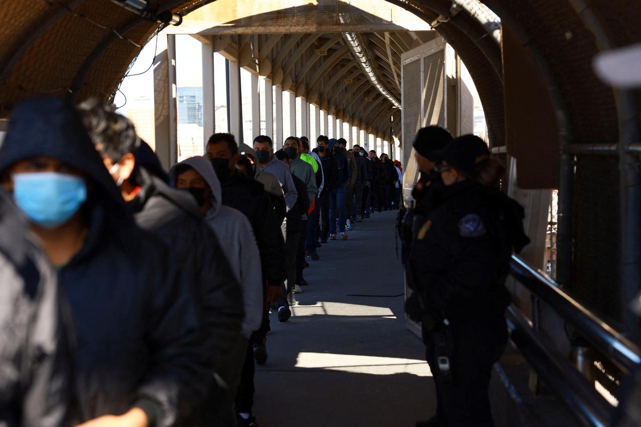 Migrants line up to leave the United States for Mexico, as seen from Ciudad Juarez