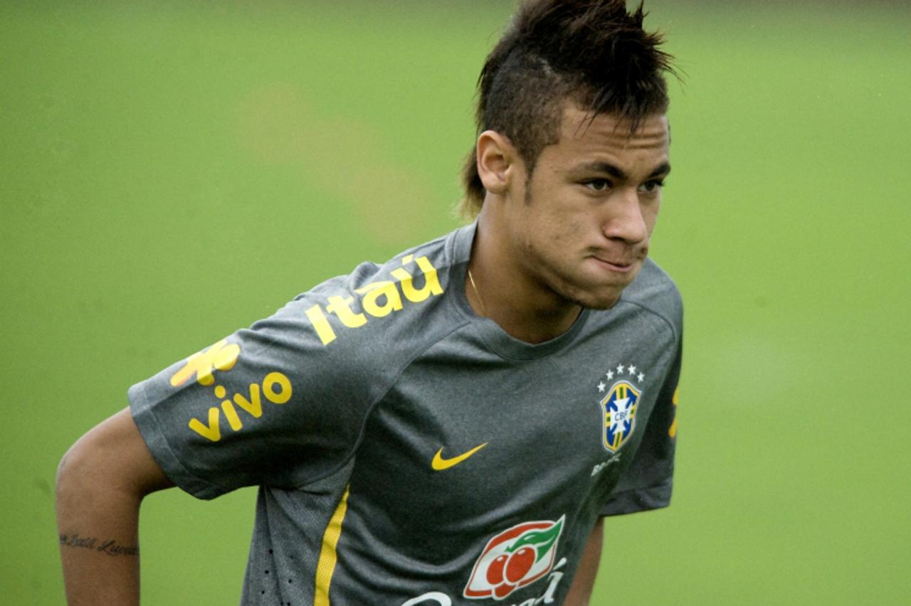 'Brazilian national football team player Neymar gestures during a training session on October 4, 2011, in San Antonio de Belen, 15 km west of San Jose, Costa Rica.  Brazil and Costa Rica will play a f