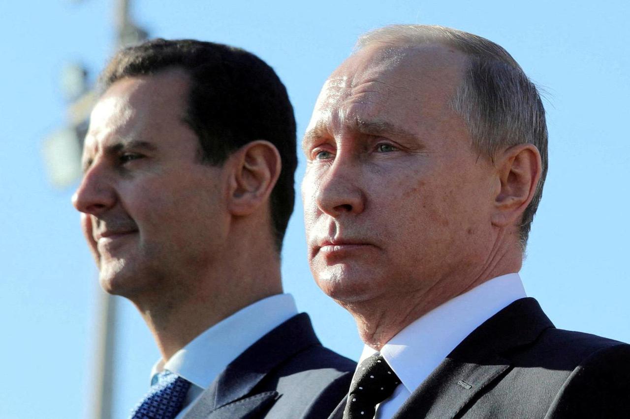 FILE PHOTO: FILE PHOTO: Russian President Putin and Syrian President Bashar al-Assad visit the Hmeymim air base in Latakia Province